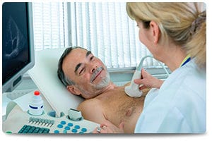 man smiling while getting chest ultrasound