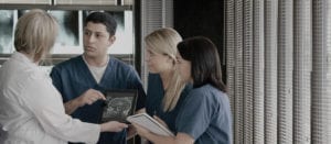 medical staff discussing medical image on tablet