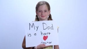 Testimonial little girl holding poster for dad