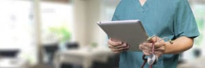 doctor with ipad looking at medical images