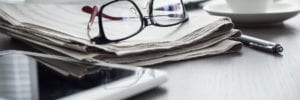 glasses newspaper and tablet