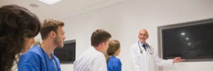 doctor with blank screen and staff