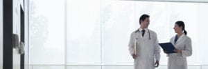 smiling doctors with medical reports
